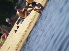 Cute brunette with black thong in the beach video