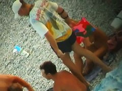 Some teen and mature couples resting at the nudist beach