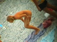 Some teen and mature couples resting at the nudist beach
