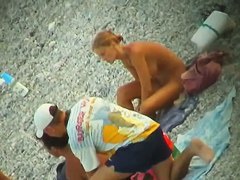 Some teen and mature couples resting at the nudist beach