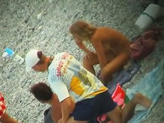 Some teen and mature couples resting at the nudist beach