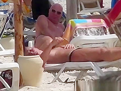 Milf topless woman creams on the beach
