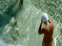 Nudist woman with small tattoo and trimmed pussy