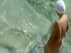 Nudist woman with small tattoo and trimmed pussy