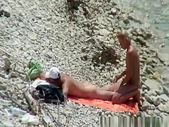 Blonde nudist woman enters the water