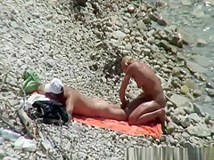 Blonde nudist woman enters the water