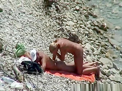 Blonde nudist woman enters the water