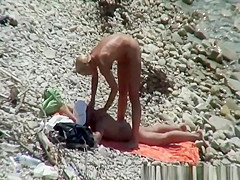 Blonde nudist woman enters the water