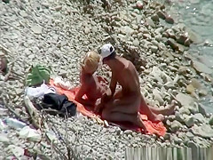 Blonde nudist woman enters the water