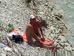 Blonde nudist woman enters the water