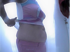 Chubby woman takes off her swimsuit