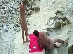 Nudist couple playing cards
