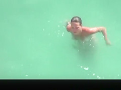 Nudist woman refreshing in the water