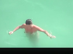 Nudist woman refreshing in the water