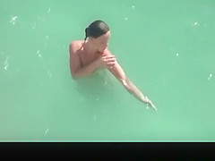 Nudist woman refreshing in the water