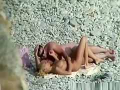 Nudist couple refreshing in water