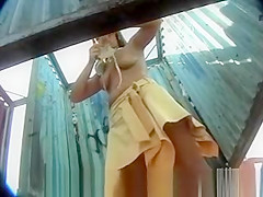 Wife changing in beach cabin