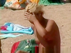 Blonde tourist with perky tits at beach