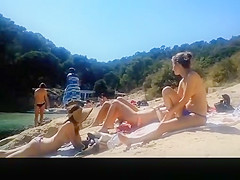Topless friends at river beach