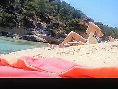Topless friends at river beach