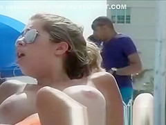 Topless beach girl with massive tits