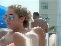 Topless beach girl with massive tits