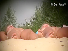Two nude girls sunbathing