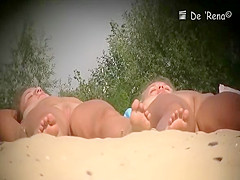 Two nude girls sunbathing