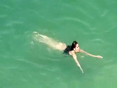 Hot woman sunbathing in beach
