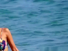 Big tits brunette girl in bikini at the beach