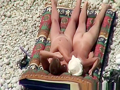 Nudist couple relaxing and sunbathing