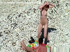 Nudist redhead swimming in the water