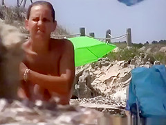 Big natural tits woman topless in the beach