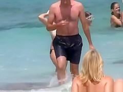 Big natural tits woman topless in the beach