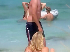 Big natural tits woman topless in the beach