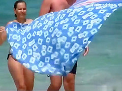 Big natural tits woman topless in the beach