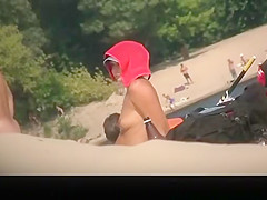 Busty topless in nudist beach