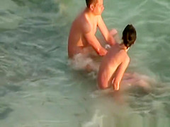 Hairy pussy nudist with glasses in the water
