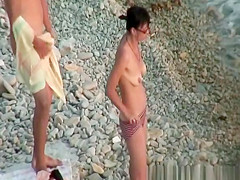 Hairy pussy nudist with glasses in the water
