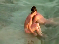 Hairy pussy nudist with glasses in the water