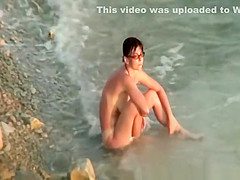Hairy pussy nudist with glasses in the water