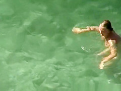 Chubby nudist woman with tattooed arm