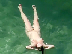 Chubby nudist woman with tattooed arm