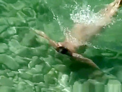 Chubby nudist woman with tattooed arm