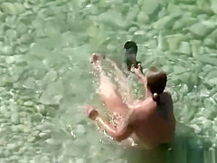 Chubby nudist woman with tattooed arm