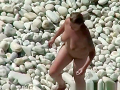 Chubby nudist woman with tattooed arm