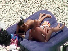 Nudist brunette woman sunbathing