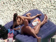 Nudist brunette woman sunbathing