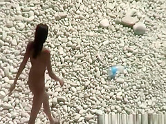 Nudist brunette woman sunbathing