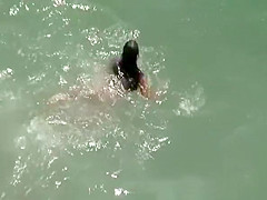 Nudist brunette woman sunbathing